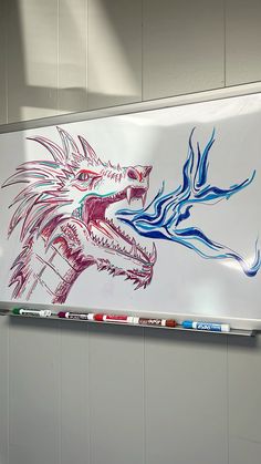 a drawing of a dragon on a white board