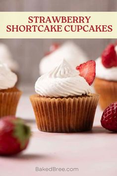 strawberry shortcake cupcakes with white frosting and strawberries on the side