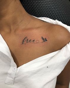 a woman's chest with the word free tattooed on her left shoulder and two birds