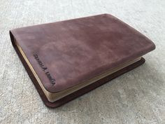 an open brown book sitting on top of a carpet