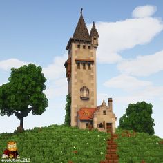 a very tall tower sitting on top of a lush green hillside next to trees and bushes