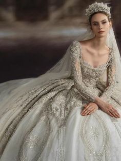 a woman in a wedding dress sitting down