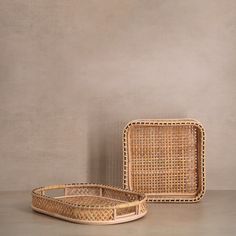 two wicker trays sitting next to each other