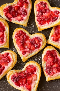 heart shaped strawberry shortbreads on a plate with strawberries