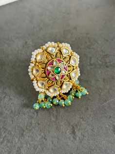 Jadau kundan statement ring in multi color with emeralds and ruby  Adjustable and with pearl detailings to amp up the antique look of the ring Perfect gift for a bride to be or Diwali gift A must have oversized ring for events where you want to have a lil extra touch to your ethnic look For order related queries, send us a message ! Thanks  Team Rosh Unique Green Festive Jewelry, Unique Festive Green Jewelry, Festive Fusion Style Toe Ring Jewelry, Festive Fusion Toe Ring Jewelry, Festive Fusion Style Toe Ring, Kundan Rings For Festivals And Gifts, Festive Kundan Ring Jewelry, Elegant Meenakari Ring Jewelry, Wedding Meenakari Toe Ring Jewelry