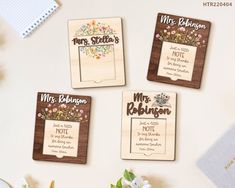 four wooden magnets with the names of three different people and flowers on them, sitting next to each other