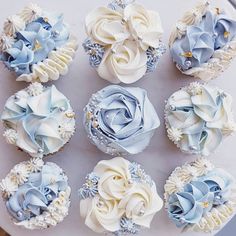 cupcakes decorated with blue and white flowers on a plate