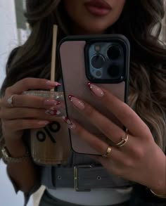 a woman holding up her cell phone to take a selfie