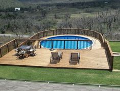 an above ground pool surrounded by wooden decking