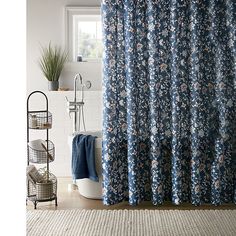 a bathroom with a blue shower curtain next to a toilet