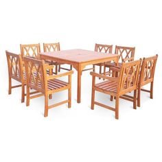 a wooden table and six chairs with one chair up against the other, set on white background