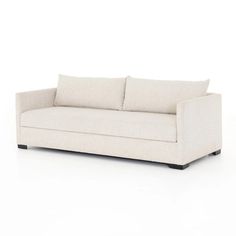 a white couch with two pillows on it