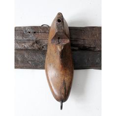 an old wooden shoe hanging on a wall