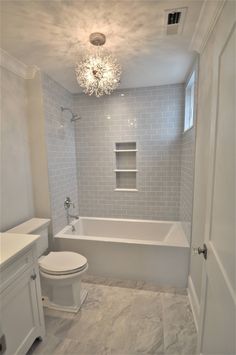 a bathroom with a toilet, tub and sink