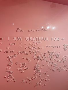 a pink wall with writing on it that says i am grateful for