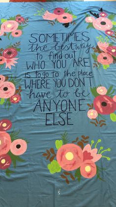 a blue blanket with flowers on it that says, sometimes the best thing to find out who you are where you don't have to be anyone else