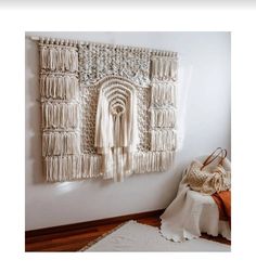 a white wall hanging with some tassels on it