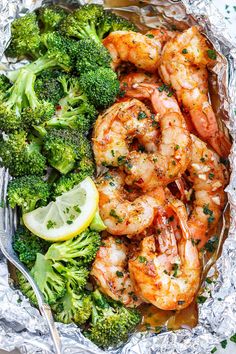 shrimp and broccoli wrapped in foil with lemon wedges