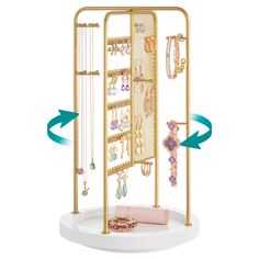 a gold jewelry rack with two arrows pointing to it