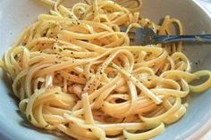 a white bowl filled with pasta and sauce