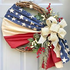 an american flag wreath hanging on the front door