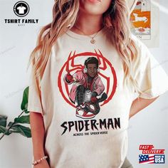 a woman wearing a spider man t - shirt