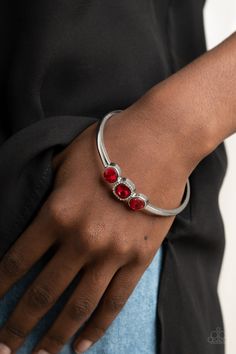 The center of a thick silver bangle has been adorned with a trio of glittery red rhinestones, creating a sparkly centerpiece around the wrist. Featuring a regal cube cut, the centermost rhinestone is bordered in a frame of glassy white rhinestones for a glamorous finish. Sold as one individual bracelet. Accessories Website, Red Bangles, Red Bracelet, Red Bracelets, Paparazzi Accessories, White Rhinestone, Red Rhinestone, Silver Bangle, Affordable Jewelry