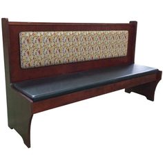 a wooden bench with floral upholstered back and seat cushion on the front, against a white background