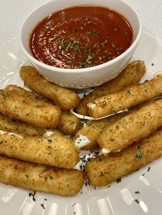 some fried food is on a plate with dipping sauce