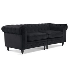 a black couch sitting on top of a white floor