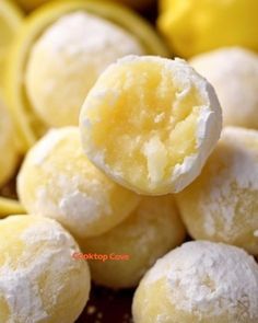 a pile of powdered sugar balls sitting next to bananas