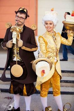 two people dressed up in costumes holding plates