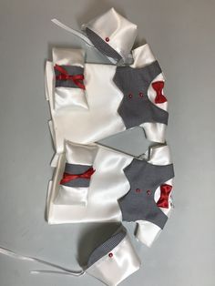 several pieces of clothing are laid out on the table together, including one with a bow tie