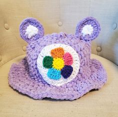 a crocheted bear hat sitting on top of a chair