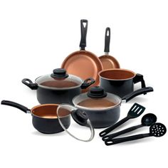 an assortment of pots and pans with utensils on the bottom one is black