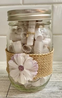 a mason jar filled with lots of white items