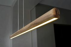 a wooden light fixture hanging from a ceiling