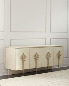 a white and gold cabinet with three doors