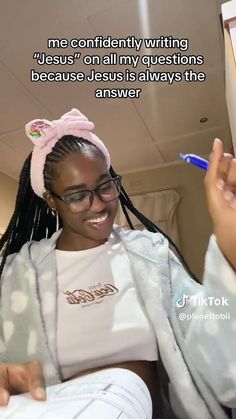 a woman with glasses and a pink bow on her head is holding a toothbrush