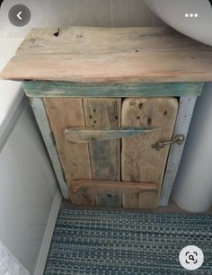 a wooden cabinet sitting next to a white sink