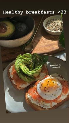 an open face sandwich with avocado and eggs on it, sitting on a plate