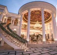 the inside of a mansion with stairs leading up to it