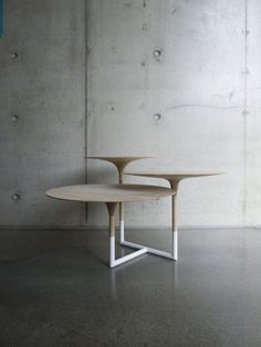 a round table sitting in front of a concrete wall