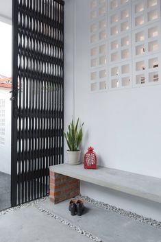 a white bench sitting next to a black door