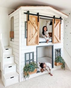 a kid's bedroom with a loft bed made out of wooden doors and windows