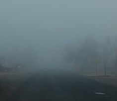 a foggy road in the middle of nowhere