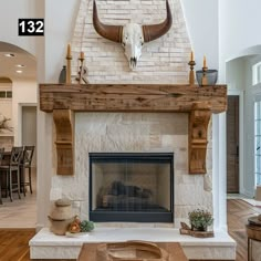 a living room filled with furniture and a fire place under a cow head mounted on the wall