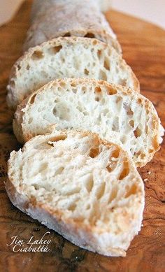 three pieces of bread sitting on top of a wooden cutting board