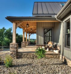 a covered patio with stone steps leading up to it