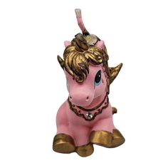 a small pink and gold unicorn figurine on a white background